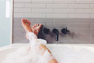Feet up relaxing in a bubble bath.